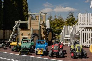 a group of toy tractors parked in front of a playground at Panocek in Białka Tatrzańska +222 photos