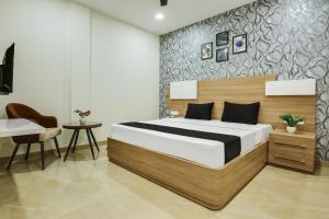 a bedroom with a bed and a table and a desk at Heritage Villa in Ludhiana