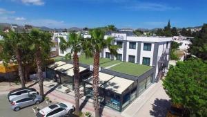 an aerial view of a white building with palm trees at My Marin Otel in Turgutreis +11 photos