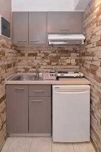 a kitchen with a sink and a stove at GARBIS Μπακάλης Θεοχάρης in Leptokarya +146 photos