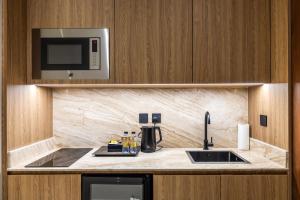 a kitchen with a sink and a microwave at ارجان بارك طويق 3 in Riyadh