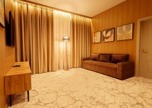 a living room with a couch and a table at EUROPA Hotel in Semey +24 photos