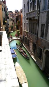 un grupo de personas montando en canoas río abajo en Balcone sul canale, en Venecia