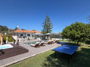 a backyard with a pool and a table and chairs at S&T VILLA in Haraki