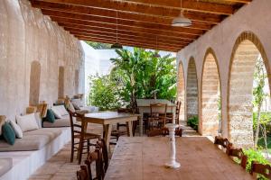 an outdoor patio with a table and chairs at Masseria Gorgognolo in Ostuni