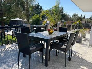 a black table and chairs on a patio at S&T VILLA in Haraki