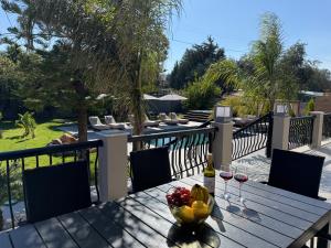 a wooden table with a bowl of fruit on a balcony at S&T VILLA in Haraki