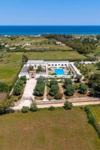 an aerial view of a building with a swimming pool at Masseria Gorgognolo in Ostuni
