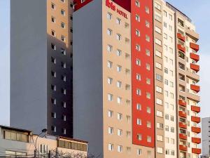 a tall building with red and white at ibis Lima Reducto Miraflores in Lima