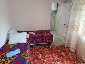 a room with a couch and a bed and a door at " UMAR " Guest house in Tong