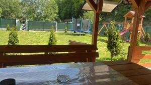 a backyard with a playground with a table and a playground at Vikendica Bosnjak in Sarajevo +6 photos