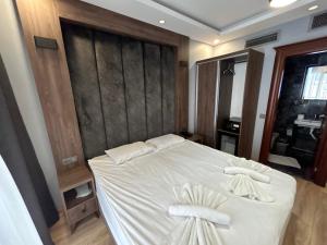 a bedroom with a white bed with two white pillows at Basilis Hotel in Istanbul