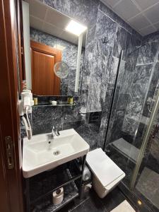 a bathroom with a sink and a shower and a toilet at Basilis Hotel in Istanbul