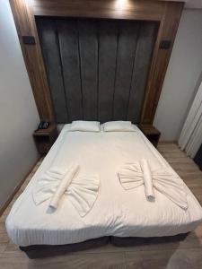 a white bed with two bow ties on it at Basilis Hotel in Istanbul +40 photos