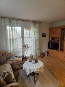 a living room with a table and a couch at GRAHLS- Ferienapartement in Feldberg