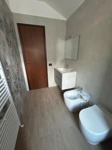 a bathroom with a white toilet and a sink at Casa delle vele in Valmadrera +22 photos