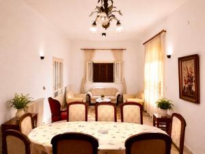a room with a table and chairs and a living room at Spacious Mountain House In Sehayleh in Ḩayy ash Shabbūq
