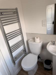a white bathroom with a toilet and a sink at The Crown in Hawes