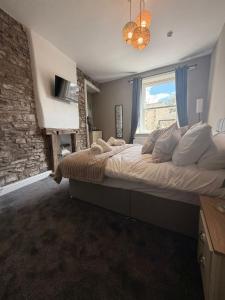 a bedroom with a large bed and a window at The Crown in Hawes