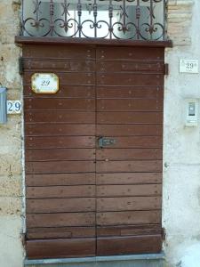 a wooden door with a balcony on top of it at La terrazza al 29 in Carbognano