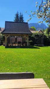 a gazebo in a field of green grass at Holiday Home Patchwork Barn in Zakopane