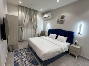a bedroom with a large bed and a television at فندق كتيفا نورث in Arar +27 photos