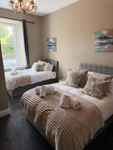 a bedroom with two beds with towels on them at The Crown in Hawes