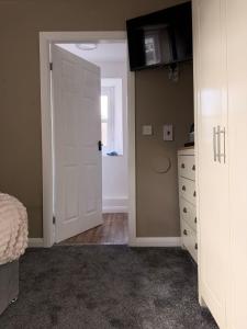a bedroom with a bed and a white door at The Crown in Hawes