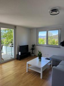 a living room with a couch and a table at Lakeview Residence in Schluchsee