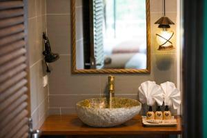 a bathroom with a sink and a mirror at Tam Coc Lion Kings Hotel & Resort Ninh Binh in Ninh Binh +71 photos