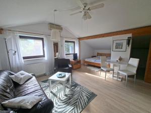 a living room with a couch and a table at Kleines Apartment in Pertitschach