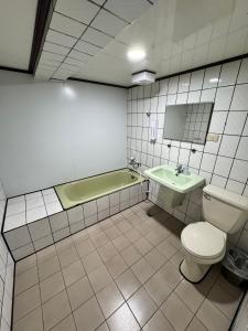 a bathroom with a toilet and a sink and a tub at 貴族旅社 宜蘭縣旅館095號 in Luodong +39 photos
