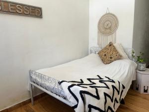 a bedroom with a zebra blanket on a bed at Beyond the city peaks in Kangra Airport