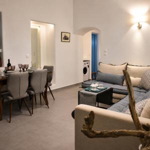 a living room with a couch and a table at Mare Bay in Adamantas