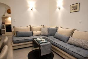 a living room with a couch and a table at Mare Bay in Adamantas