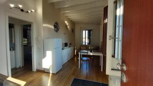 a kitchen with a white refrigerator and a table at Cavour 35 in Sulbiate +46 photos