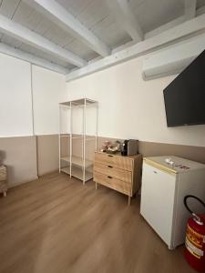a room with a refrigerator and a shelf in it at ComfortHouse AlbatrosMare in Ladispoli