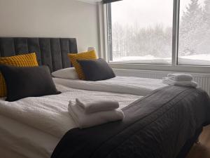 a bedroom with two beds with towels on them at Hotel Hvolsvollur - Central South Iceland in Hvolsvöllur +51 photos