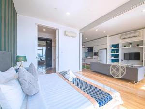 a bedroom with a bed and a living room at The Platinum Kuala Lumpur by LUMA in Kuala Lumpur