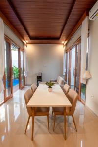 a dining room with a table and chairs at Sawitri Ubud Villas in Blahbatu