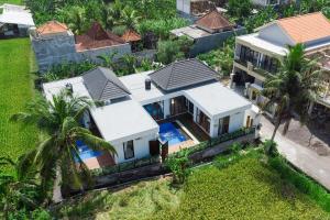 an aerial view of a house with a swimming pool at Sawitri Ubud Villas in Blahbatu