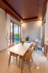 a dining room with a table and chairs at Sawitri Ubud Villas in Blahbatu