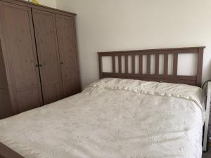 a bedroom with a bed and two dressers at Terraced apartment in Kayl