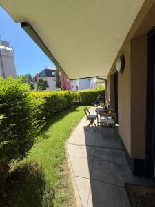 a patio with a table and chairs on the side of a house at Terraced apartment in Kayl +3 photos