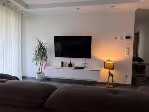 a living room with a flat screen tv on a wall at Terraced apartment in Kayl