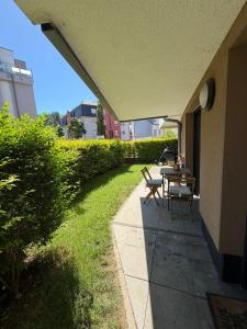 a patio with a table and bench on the side of a building at Terraced apartment in Kayl
