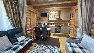 a kitchen and a living room with a table and chairs at Казковий Світязь in Szack
