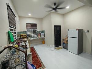 a kitchen with a ceiling fan and a refrigerator at D'Jawa Homestay in Baling +6 photos