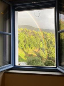a rainbow seen through a window with a view at Villa Gioia Agriturismo in Monterosso al Mare +6 photos