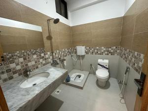 a bathroom with a sink and a toilet at Taj luxury hotel Quetta in Quetta